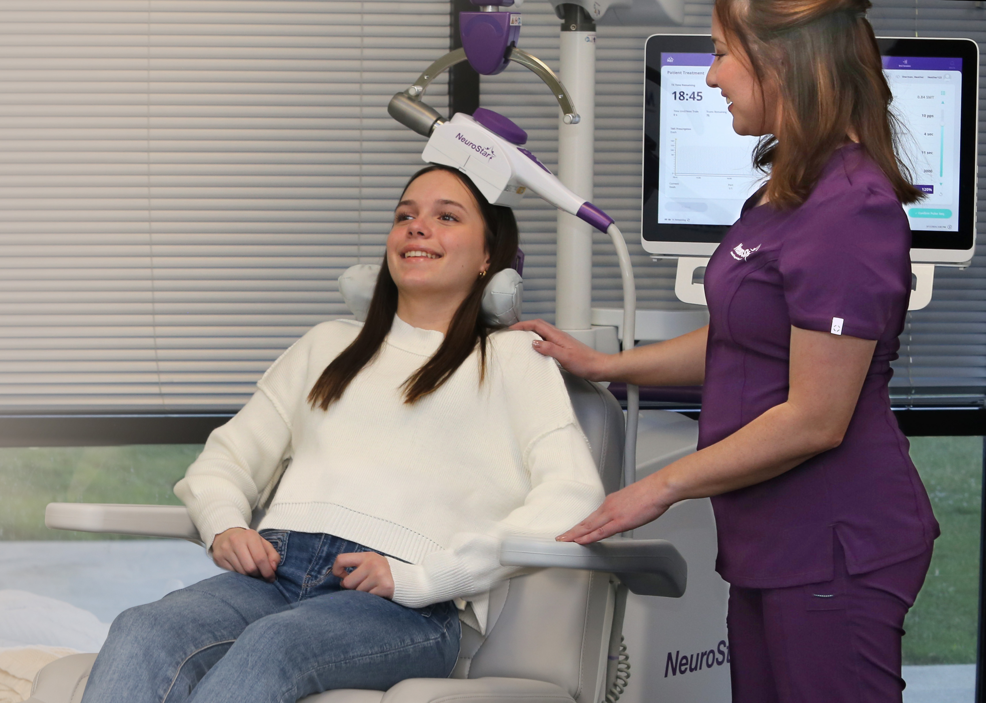 An adolescent patient receiving NeuroStar TMS therapy, seated comfortably while a ReNew Wellness clinician guides the session